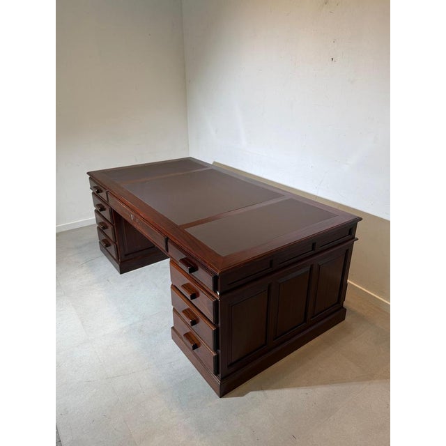 A beautiful antique double-sided executive desk crafted in rich mahogany. This impressive desk is designed to be viewed...