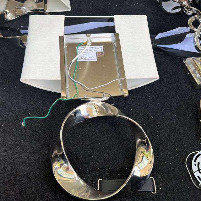 1- Polished Nickel twisted circle sconces .