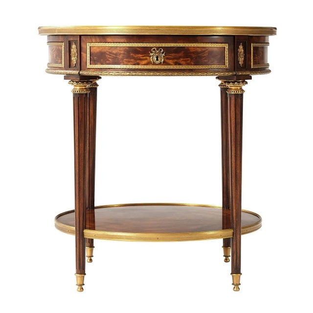 A French Louis XVI Style mahogany and Okum Bouillotte table with fine brass mounts, the circular brass bound white-veined...