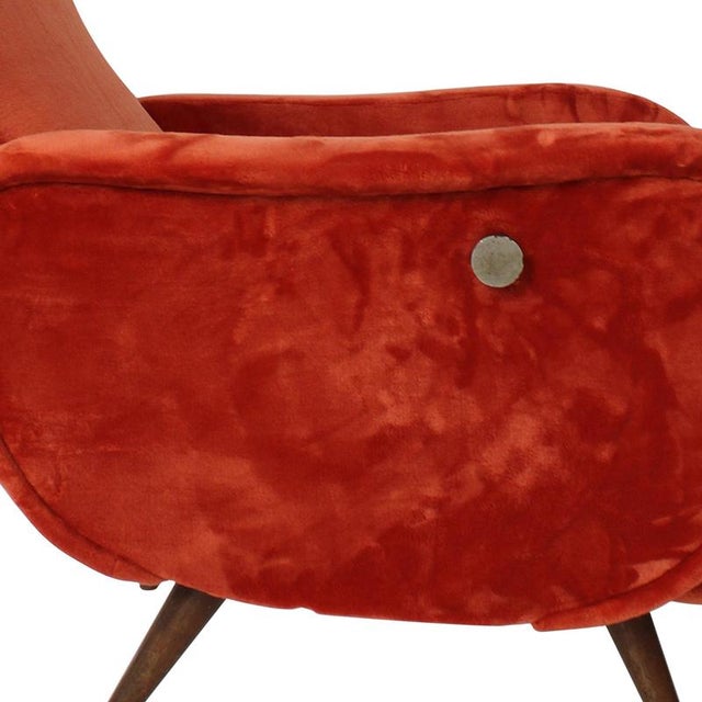 Elegant reclining armchair upholstered in rich red velvet, dating from the 1950s. This vintage piece features a high...