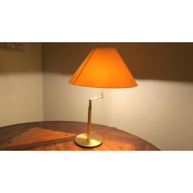 Relux Milano Italian mid century table lamp or reading lamp in brass. The lamp is multi-adjustable by means of a swing...