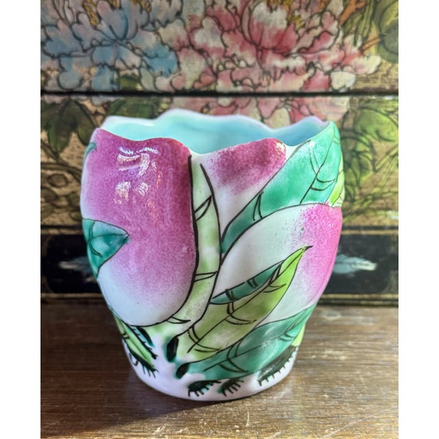 This is a lovely & vibrant Vintage Chinese Famille Rose Longevity Peach Porcelain Cup or Brush Pot from the Mid-Century....