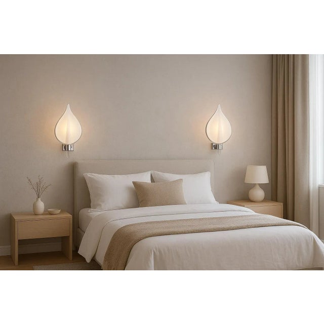 Stunning pair of wall sconces attributed to Franco Luce. Design period 1970. A beautiful and elegant design object for any...