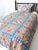 Antique yo-yo quilt dating to the 1920s–1940s, showcasing a charming patchwork design created from colorful fabric circles...