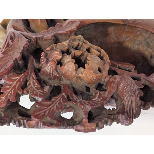 A beautiful Chinese soapstone art piece featured flowers, a bird, and a basket, a great gift for oriental art lovers.