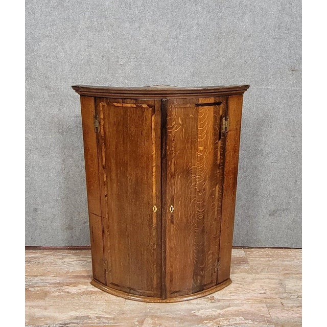 18th-century oak and marquetry corner cabinet, circa 1780 Arched front with two doors Painted wood interior Original...