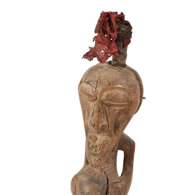 A fantastic miniature Songye Power Fetish Figure from Congo. Standing at 10 inches in height, this miniature carving holds...