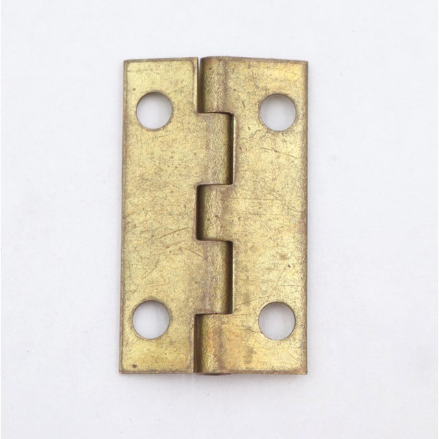 Vintage cabinet door hinge made of polished brass with flat tips, five knuckles, and a template hole pattern. The original...