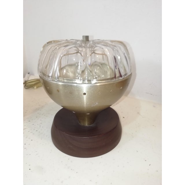 Pair of original vintage table lamps in brass-plated metal, prismatic glass, and carved wood. Fair overall condition. Some...