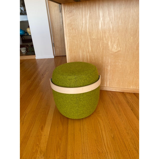 Carry On stool or pouf designed by Mattias Stenberg, featuring a bright green textured fabric and a practical bentwood...