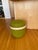 Carry On stool or pouf designed by Mattias Stenberg, featuring a bright green textured fabric and a practical bentwood...