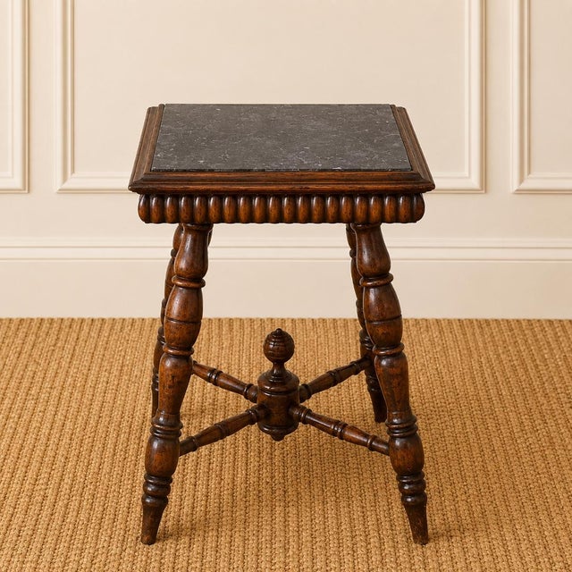This elegant 19th century English oak side table pairs a rich gray marble top with a beautifully turned and carved wood...