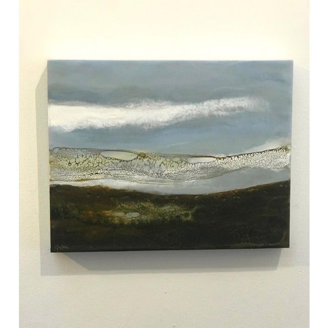 Earth Sky Sea captures the serene meeting of land and sky through a rich interplay of colors and textures. The encaustic...