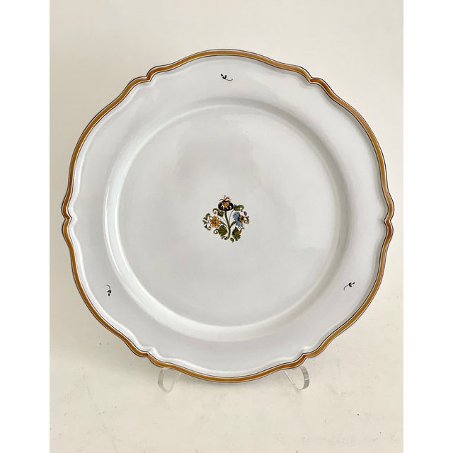 French Faience scalloped platter or charger from Moustiers-Sainte-Marie hand-painted and signed by the artist. There are...