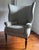 Make a commanding statement with this striking, high-back Hepplewhite-style wing armchair. Showcasing an elegant,...