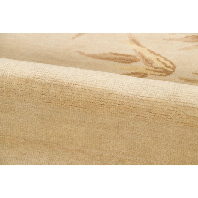 This 3x4 contemporary Chinese Deco rug features delicate floral branches and stylized leaves arranged across a softly...
