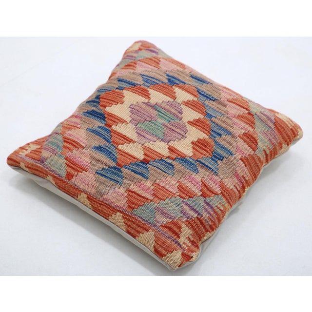 A one-of-a-kind handwoven Afghan wool kilim accent pillow featuring diamond lattice. Cut and sewn by hand from a flat-...