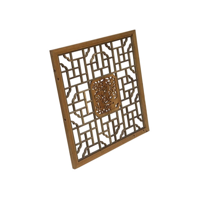 This square, hand-carved wooden screen is a beautiful example of traditional Chinese fretwork, often used as a window...