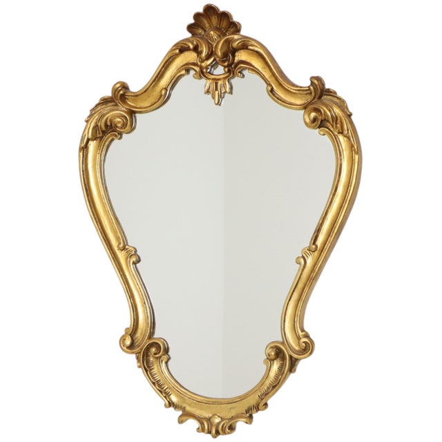 Large vintage mirror with a decorative crest, crafted in a classic Baroque style from resin and finished with gold leaf;...