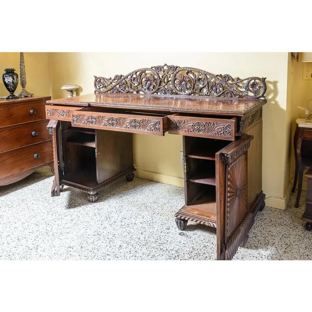 Beautiful, Anglo-Indian server. With wonderful carved details, three drawers, and two bottom cabinets