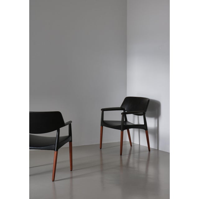 Large armchairs in solid teak and black leather made by cabinetmaker Willy Beck, Copenhagen in the 1950s. The chairs was...