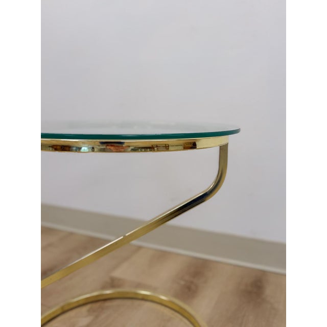 This striking vintage brass angular end table in the style of Milo Baughman is a bold and sophisticated postmodern accent...