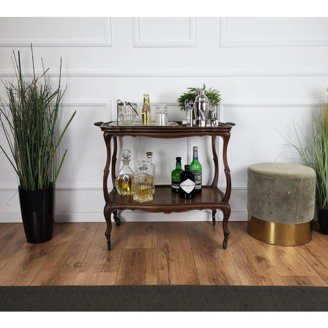 Unique and very elegant Italian Chippendale dry bar cabinet cart with two tiers and highlighted by the great wooden...