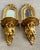A beautiful antique pair of giltwood carved hanging shelves with mirrors and winged putti holding a shelf. The arched...