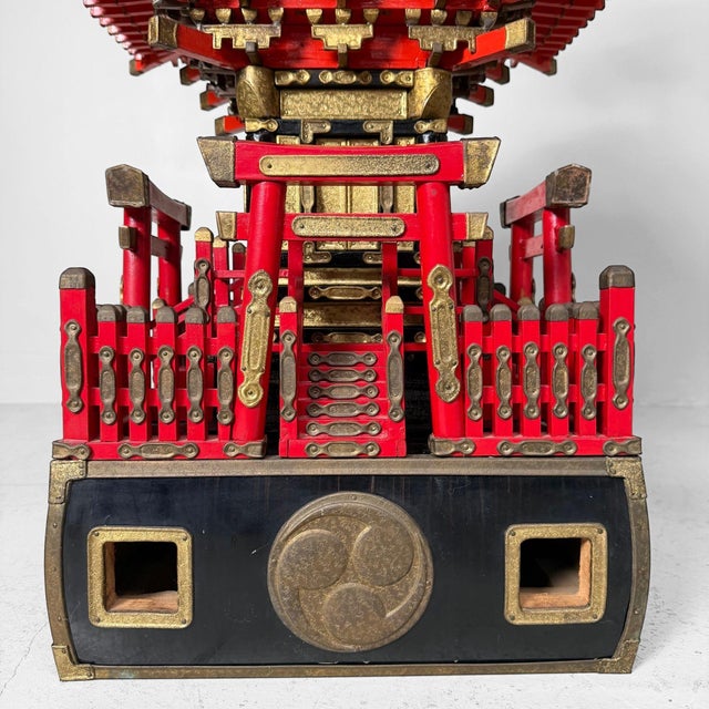 A richly decorated Japanese mikoshi, a portable Shinto shrine with red lacquer, gilt metal fittings, and an elegant bird...