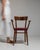 This piece presents as a piece, distinguished by dark walnut, red painted seat. The piece dates to 1940s, sourced from...