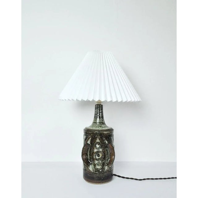 Ceramic Table lamp with a sculpturel abstract expression. Glaze in various tones of grey, turquis, green, brown and black....