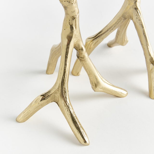 Made from handsculpted molds and in solid cast aluminum, these tall and slender taper holders in warmGold are a...
