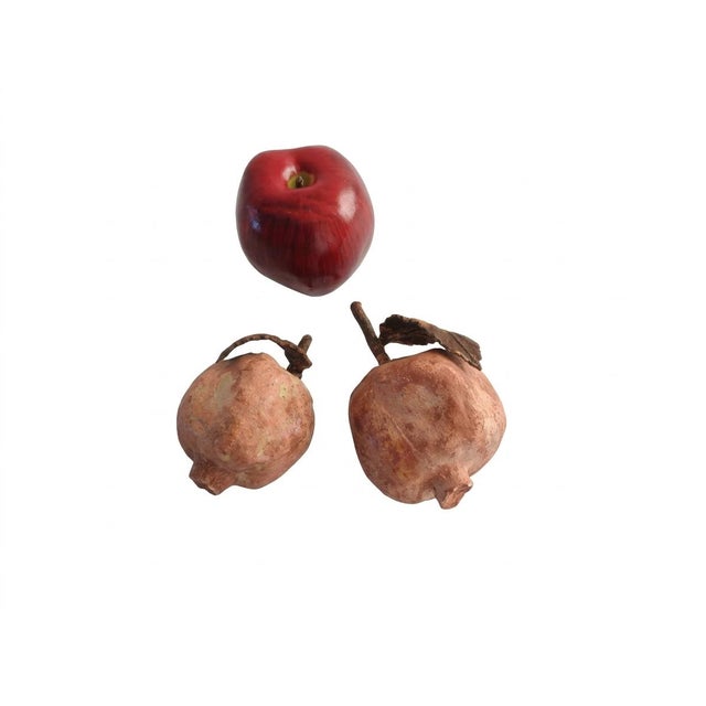 A charming set of two hand-molded terracotta pomegranate sculptures featuring intricate organic surface texturing and...