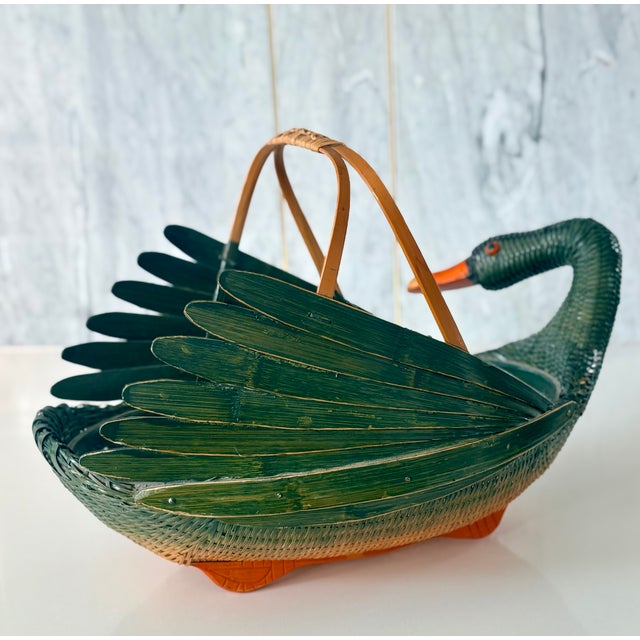 This graceful hand-woven rattan wicker basket in the shape of a swan is truly a vintage (circa 1970's) work of art and in...
