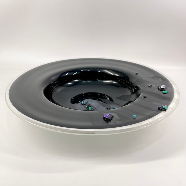 A striking example of late 20th-century American studio art glass, this large fused glass charger by renowned...