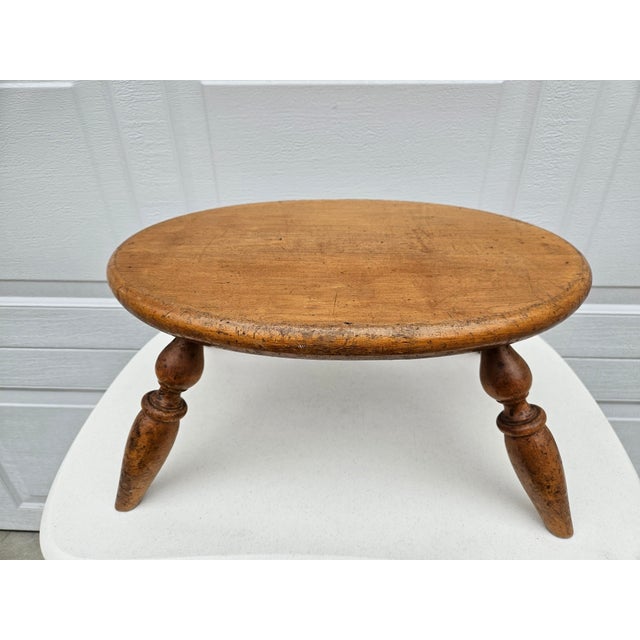 This classic milking stool is supported by turned legs pegged directly into the thick oval seat. The underside edge of the...
