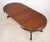Victorian style round dark toned walnut table with a turned pedestal column and four carved splay legs. The table can be...