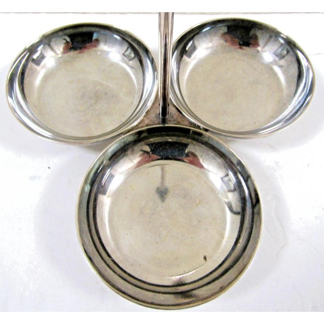 The London Ritz Carlton Gebruder Hepp Silverplate 18/10 Three Bowl Condiment Server is a luxurious and elegant piece...