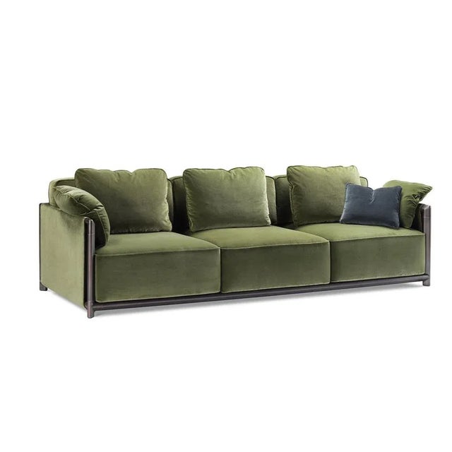 Plush volumes featuring a rich padding and a classy, olive-green fabric upholstery lend this sofa its pampering feel still...