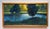 The artwork depicts a serene landscape, where vibrant green foliage contrasts with the shimmering gold light of the...
