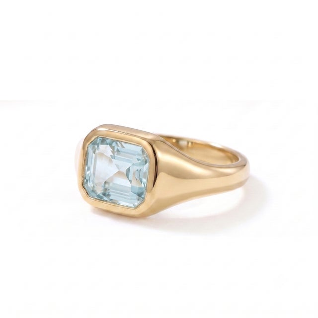 A modern interpretation of the classic signet ring, this elegant design showcases a serene aquamarine in a sleek bezel...