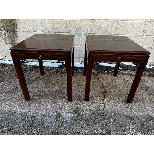 These end tables are made in the Chinese Chippendale style. The tops are made of a burlwood inset. They have writing...