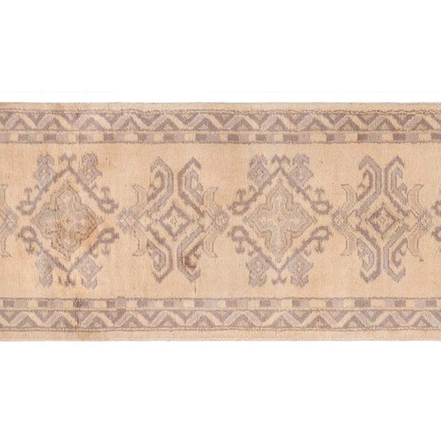 Step into the subtle elegance of early 20th-century Anatolia with this exquisite Antique Turkish Oushak runner, handwoven...