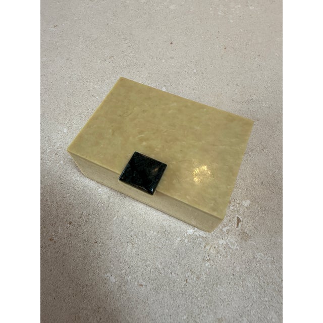 Elegant vintage trinket box crafted from creamy faux marble lucite, featuring a smooth, polished finish with subtle...