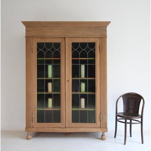 An exceptional display cabinet from the early 20th century. Solid oak with leaded glass. Refurbished ready for everyday...
