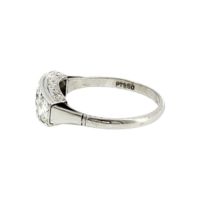 A 1920s platinum three-stone ring featuring European cut diamonds. The total carat weight of the 3 diamonds is...