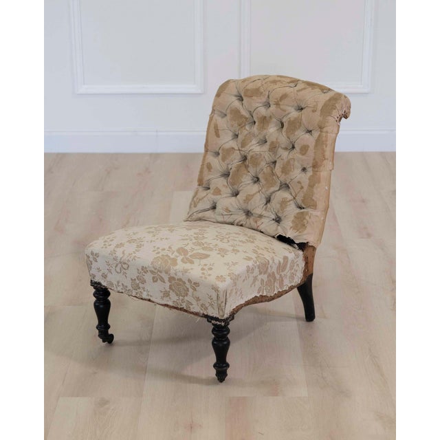 Elegant 19th century French slipper chair featuring a low-profile silhouette and refined proportions. The frame exhibits...