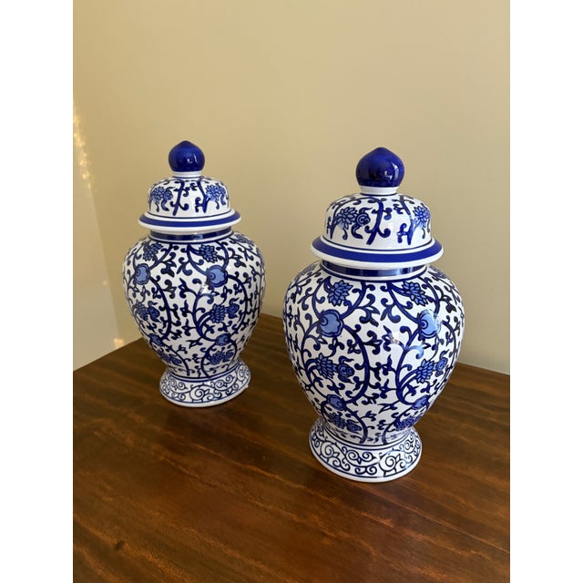 A beautiful pair of Chinoiserie blue and white porcelain covered ginger jars China, Late 20th Century Measures: 7ʺW × 7ʺD...