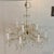 Traditional Maria Theresa style crystal chandelier, often featuring a gold finish and glass arms decorated with strands of...