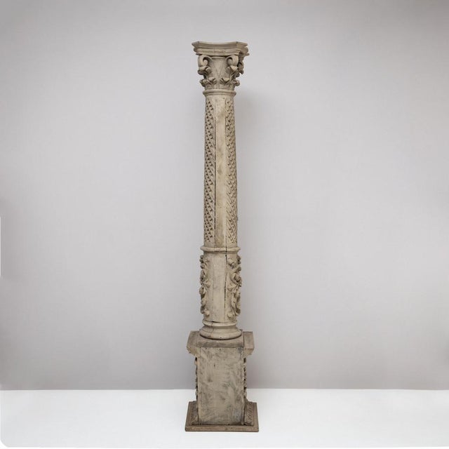 A tall historicist column crafted from carved wood, dating to the 19th century. The column is painted in gray and rests on...